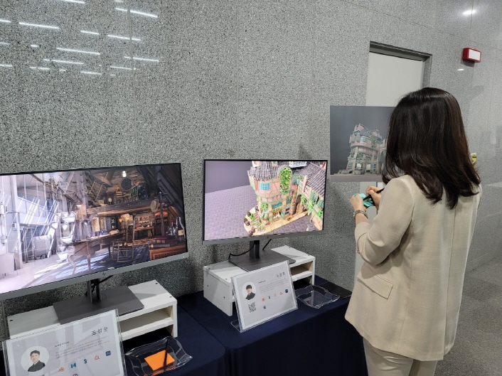 사진 4. 콘진원은 대한민국 게임산업의 미래를 이끌 인재를 양성하고자 게임인재원을 운영하고 있으며, 5일(월) 게임인재원 1기 졸업전시회에서 참석자가 졸업생들이 개발한 게임의 아트웍을 관람하고 있다. 